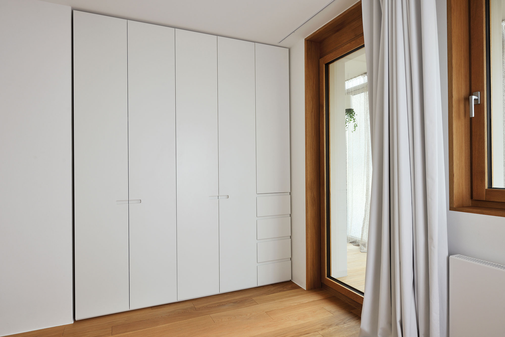 An Elegant L-Shaped Apartment with Walls of Modular Shelving and Storage in Ljubljana by Lidija Dragisic (12)