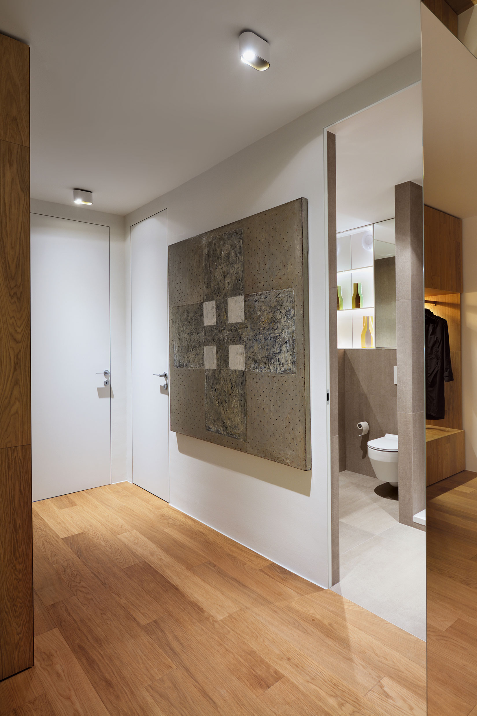 An Elegant L-Shaped Apartment with Walls of Modular Shelving and Storage in Ljubljana by Lidija Dragisic (13)