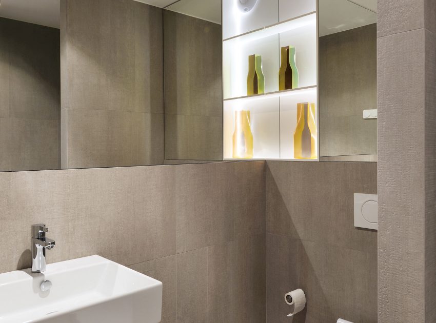 An Elegant L-Shaped Apartment with Walls of Modular Shelving and Storage in Ljubljana by Lidija Dragisic (15)