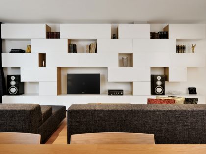 An Elegant L-Shaped Apartment with Walls of Modular Shelving and Storage in Ljubljana by Lidija Dragisic (4)