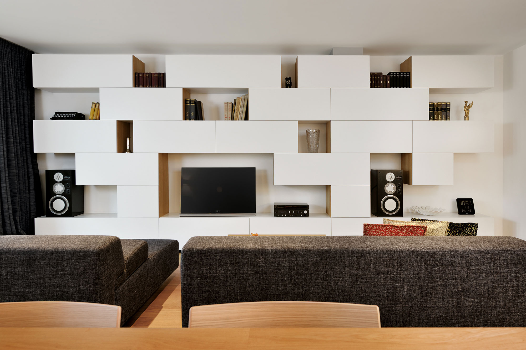 An Elegant L-Shaped Apartment with Walls of Modular Shelving and Storage in Ljubljana by Lidija Dragisic (4)