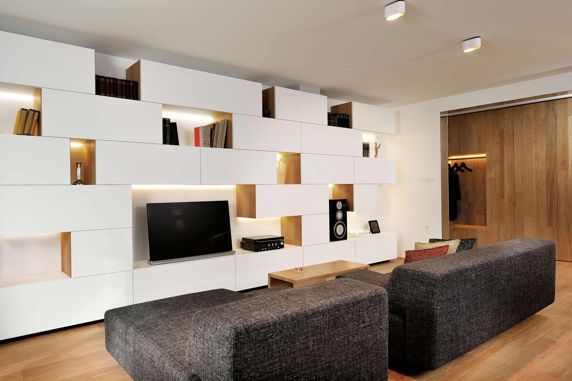 An Elegant L-Shaped Apartment with Walls of Modular Shelving and Storage in Ljubljana by Lidija Dragisic (5)