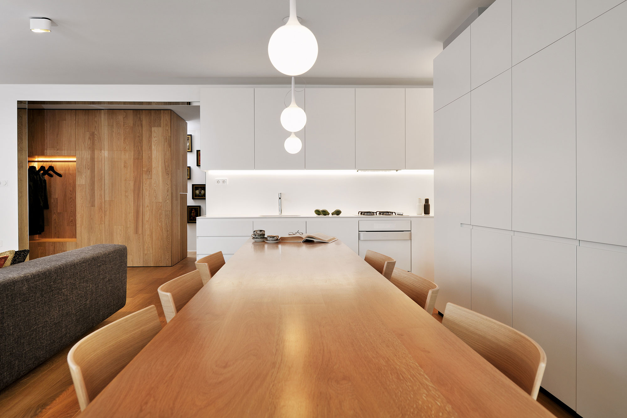 An Elegant L-Shaped Apartment with Walls of Modular Shelving and Storage in Ljubljana by Lidija Dragisic (8)