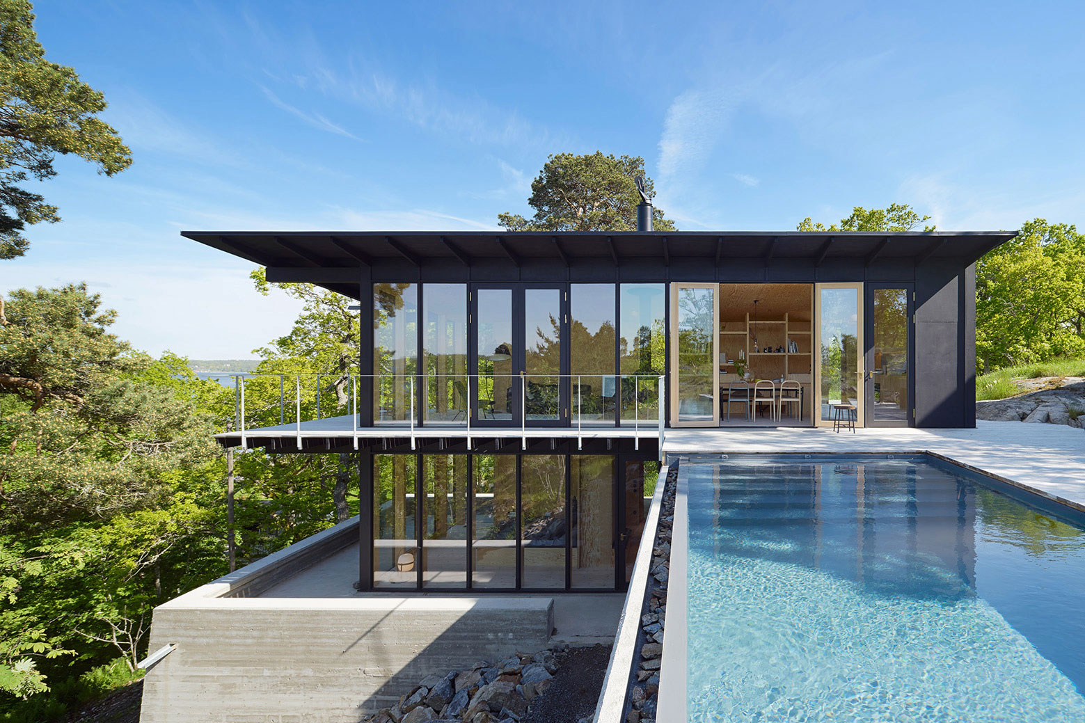 A Small Steel, Wood and Glass House Built on Steep Slope with Infinity Pool in Aspvik by Andreas Martin-Löf Arkitekter (1)