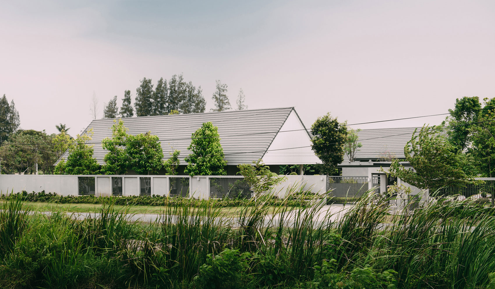 A Stunning Contemporary Triangle House with Gabled Walls in Nakhon Pathom, Thailand by Phongphat Ueasangkhomset (1)