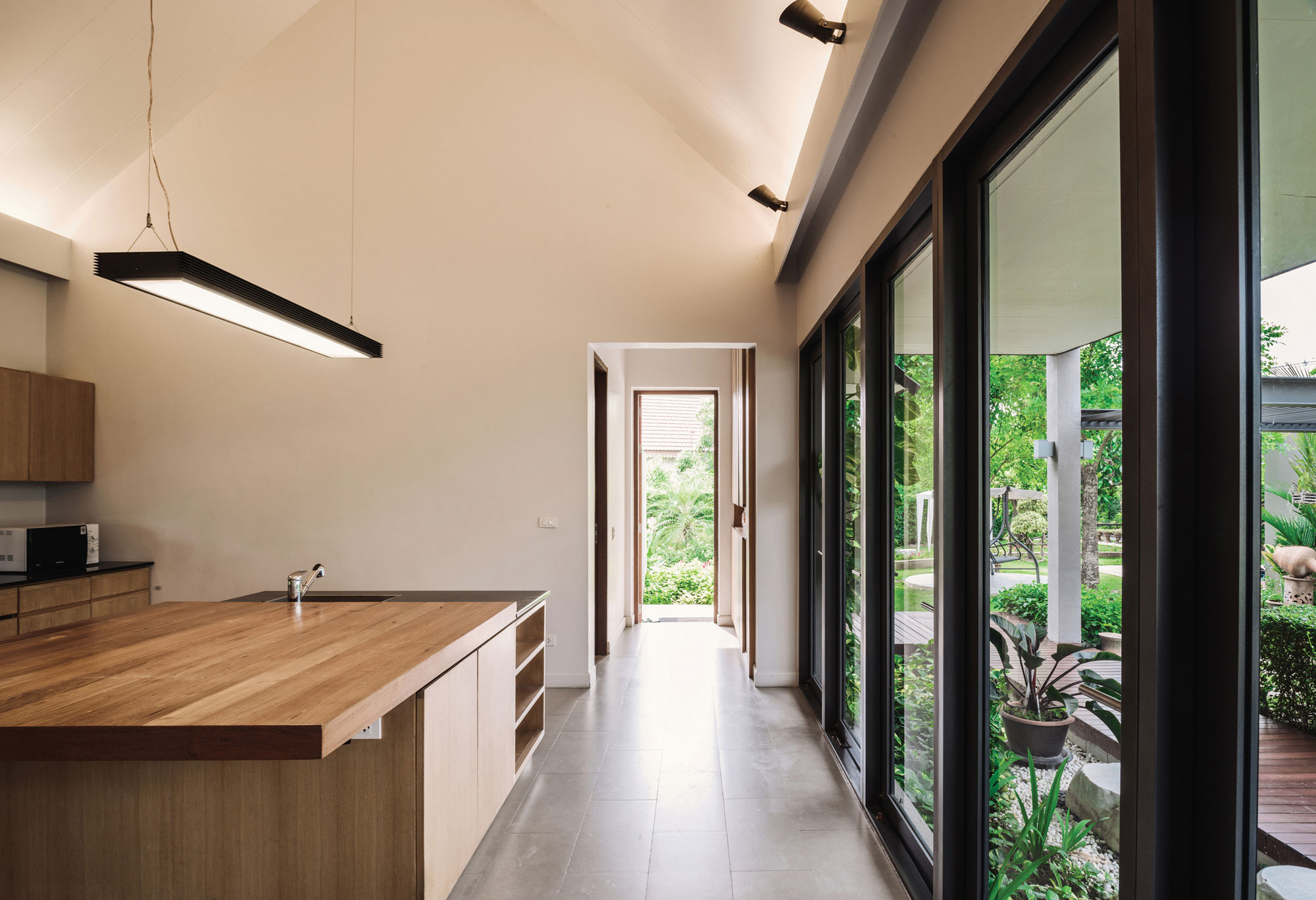 A Stunning Contemporary Triangle House with Gabled Walls in Nakhon Pathom, Thailand by Phongphat Ueasangkhomset (10)