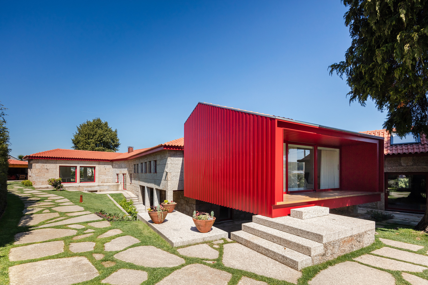 A Beautiful and Bright Red House Overlooks a Stunning Landscape in Vila Nova de Famalicão, Portugal by NOARQ (1)