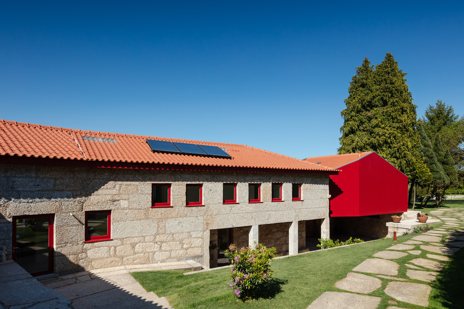 A Beautiful and Bright Red House Overlooks a Stunning Landscape in Vila Nova de Famalicão, Portugal by NOARQ (3)