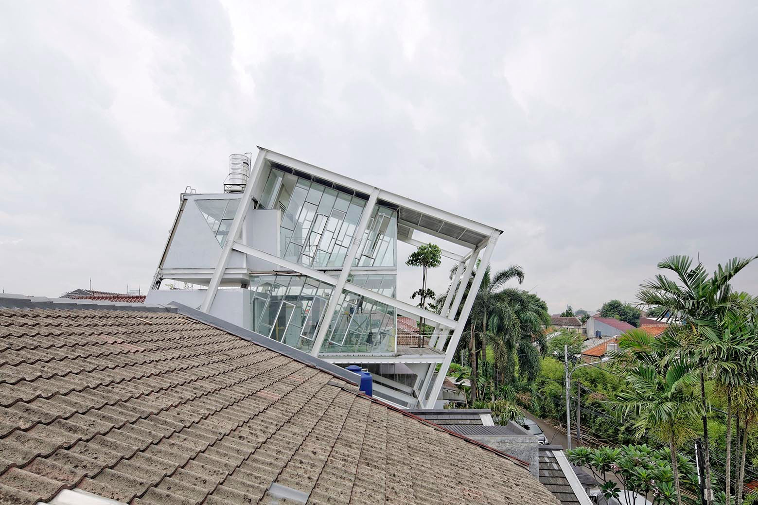 A Stunning Glass House with Slanted Steel Frame and Indoor Pool in Jakarta by Budi Pradono Architects (2)