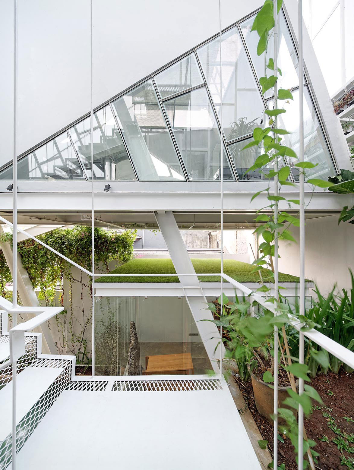 A Stunning Glass House with Slanted Steel Frame and Indoor Pool in Jakarta by Budi Pradono Architects (3)