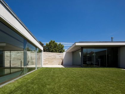 An Elegant Modern House with Courtyards and Pool Flanked by Stone Walls in Porto, Portugal
