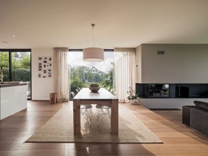 A Bright Modern Home with White Facade and Large Glass Windows in Uitikon, Switzerland by Meier Architekten (11)