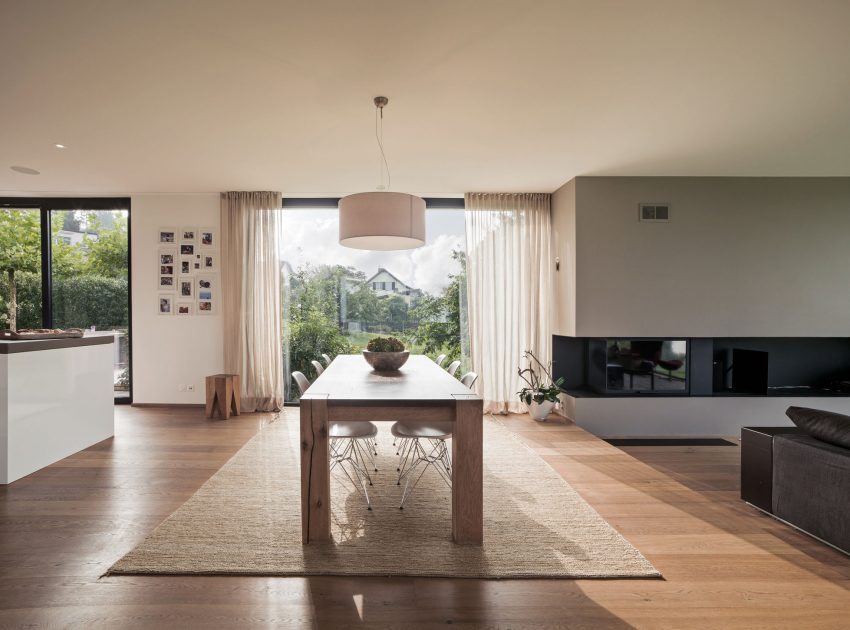 A Bright Modern Home with White Facade and Large Glass Windows in Uitikon, Switzerland by Meier Architekten (11)