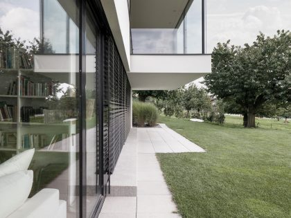 A Bright Modern Home with White Facade and Large Glass Windows in Uitikon, Switzerland by Meier Architekten (6)