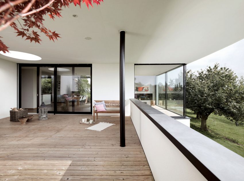 A Bright Modern Home with White Facade and Large Glass Windows in Uitikon, Switzerland by Meier Architekten (7)